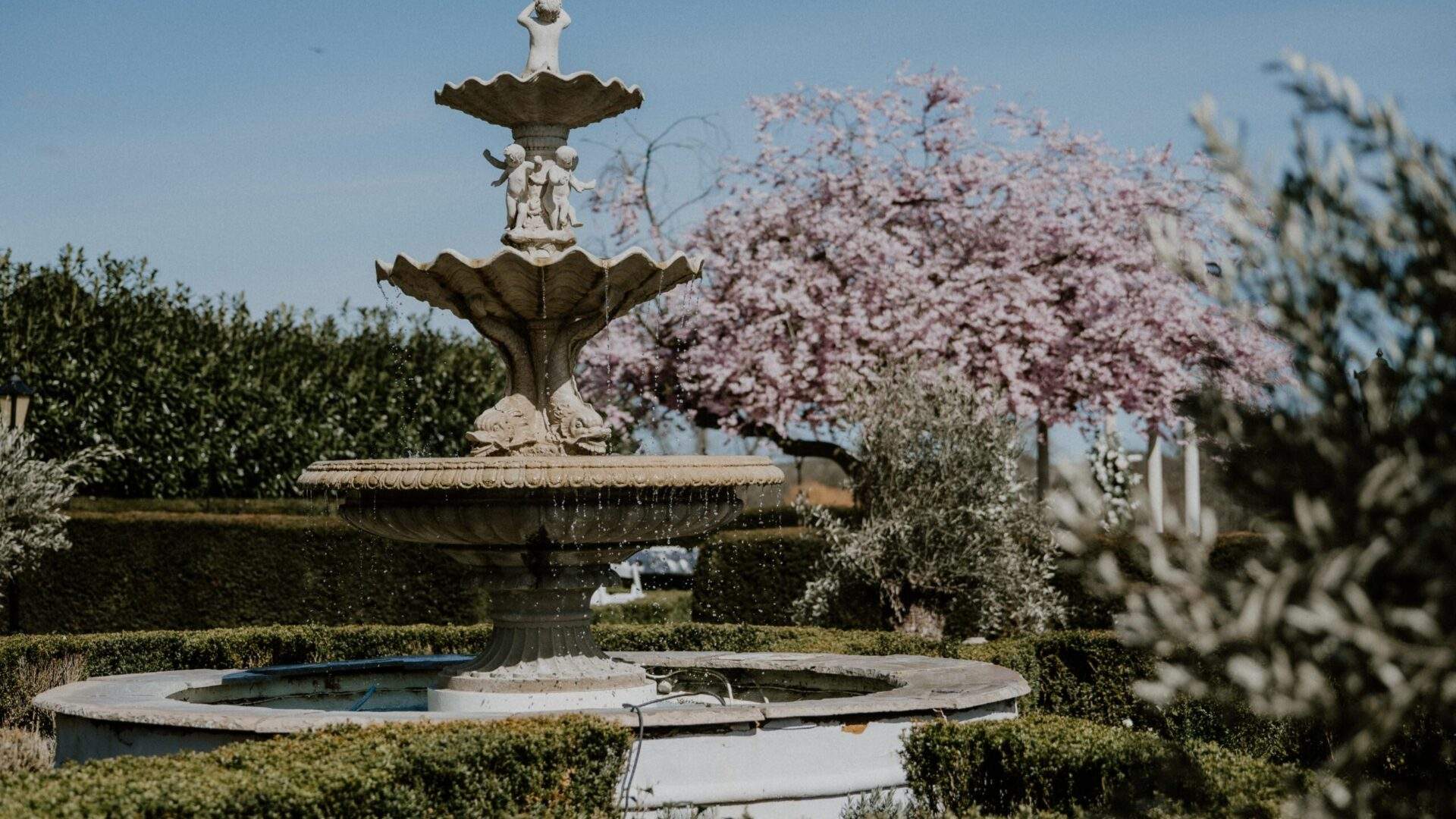 Froyle Park, a country house wedding venue in Hampshire, has classical stone water fountains - beautiful photo backdrops.