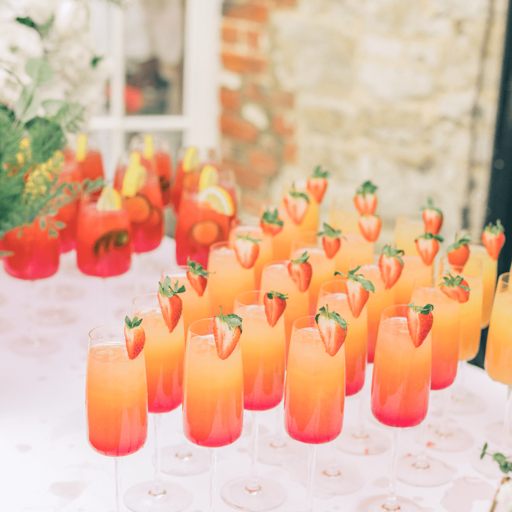 A selection of colourful cocktails and mocktails, displayed in the atrium at Froyle Park with it's wonderful original exposed brick and stone work
