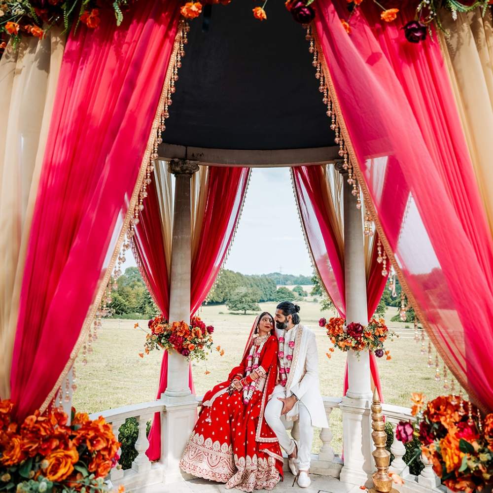 An South Asian Bride & Groom at their outdoor wedding Mandap ceremony at Froyle Park
