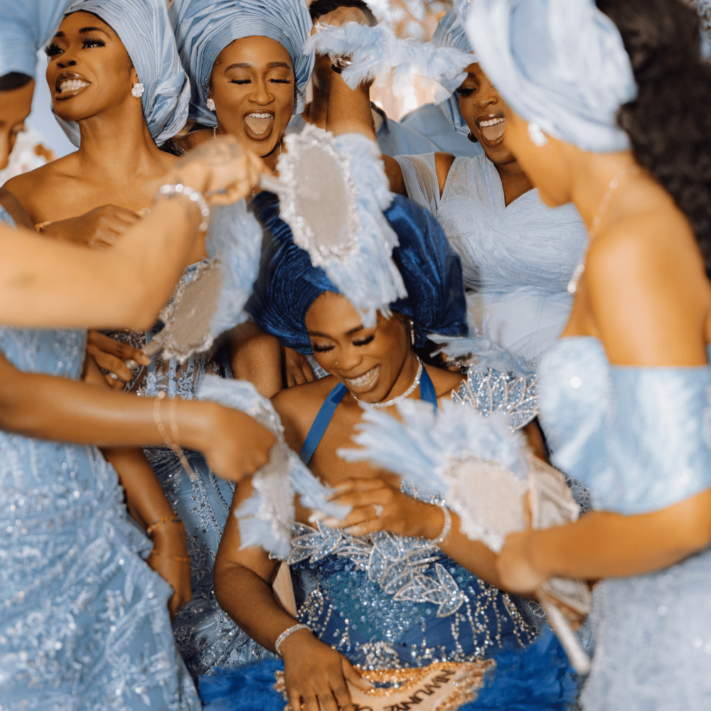 A Nigerian bride in traditional attire at her Yoruba traditional wedding at Froyle Park is showered with money