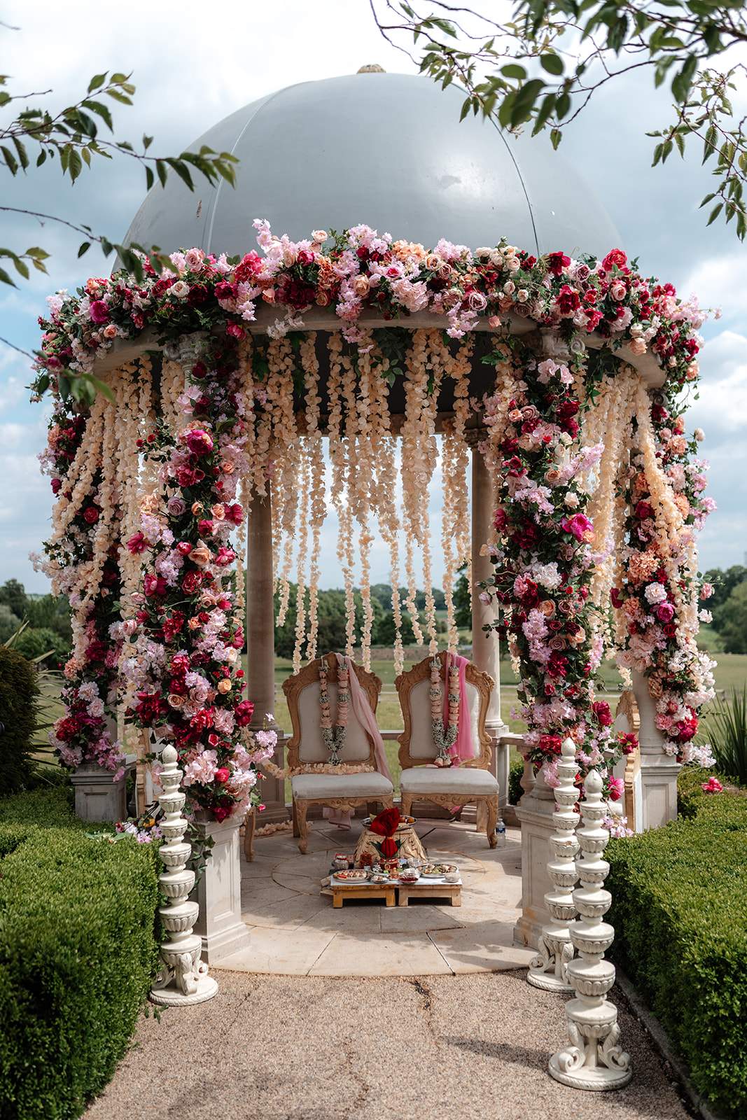 Stunning outdoor mandap at Froyle Park, adorned with florals