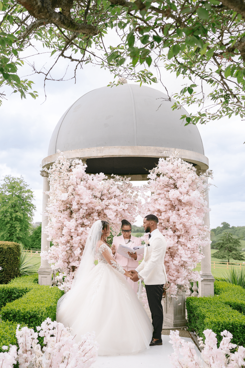 A Bride and groom exchange vows beneath the iconic Froyle Park Dome