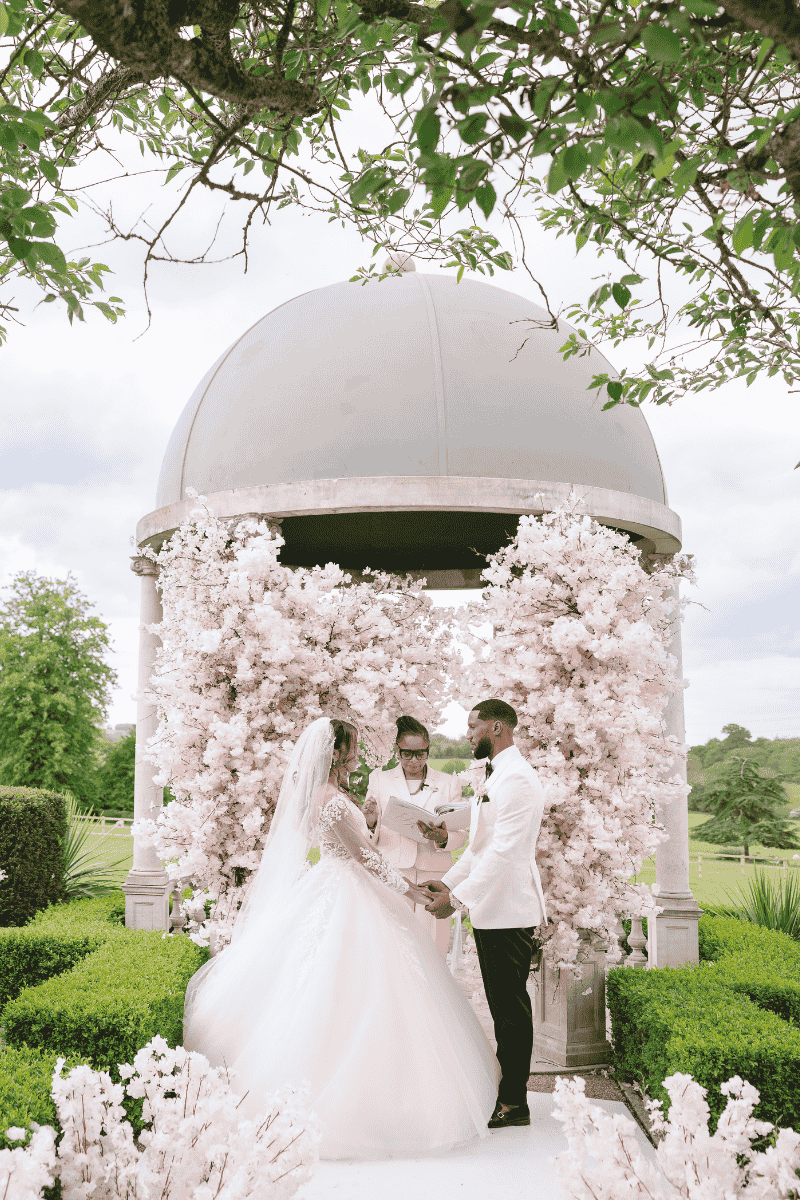 A Bride and groom exchange vows beneath the iconic Froyle Park Dome