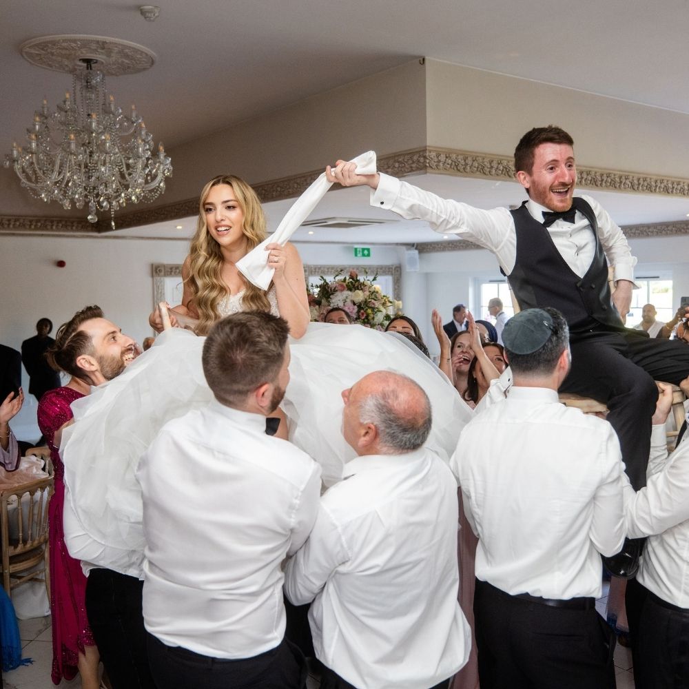 The Jewish chair lift dance during the Hora of a Jewish wedding at Froyle Park in Surrey.