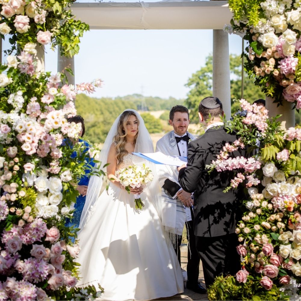 A Jewish Bride & Groom break the glass at their Chuppah ceremony at the iconic Dome at Froyle Park Wedding Venue in Surrey.