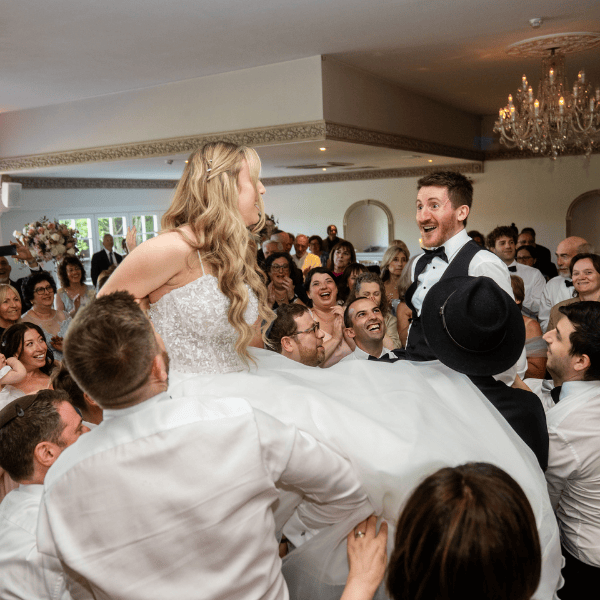A Jewish bride and groom enjoy the Hora at their wedding reception at Froyle Park