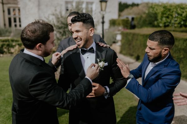 A Groom greets hhis ushers at Froyle Park wedding venue in Hampshire