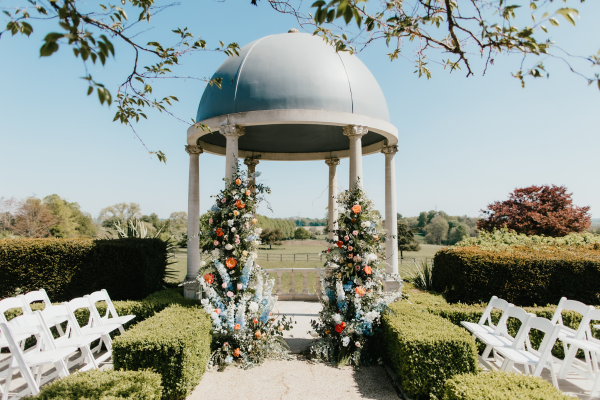 The Dome at Froyle Park prepared for an outdoor wedding ceremony overlooking the Hampshire countryside