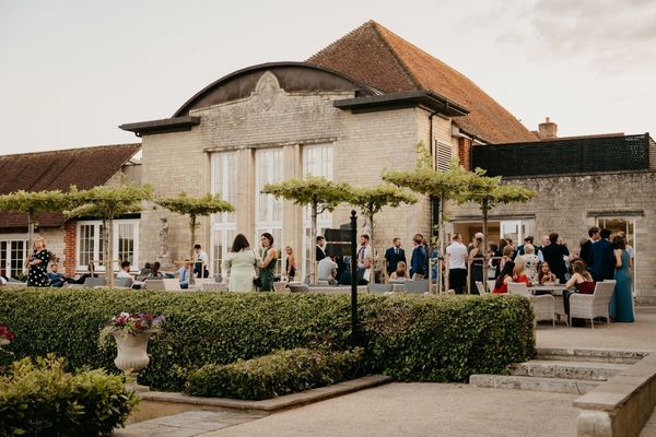 Guests enjoy drinks on The Terrace at Froyle Park in Hampshire