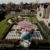 Elegant outdoor wedding ceremony setup in Froyle Park Gardens in Hampshire, featuring a blooming pink blossom tree