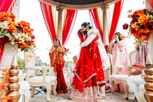 Traditional Hindu wedding ceremony at Froyle Park featuring a mandap beneath the Dome and vibrant cultural décor.
