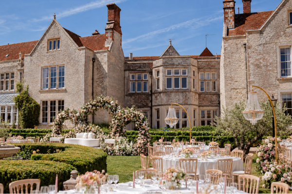 A beautiful outdoor wedding reception at Froyle Park, int he shadow of the historic Jacobean Manor
