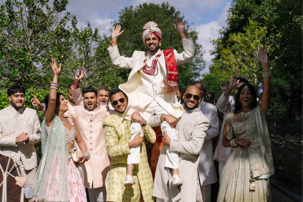 A Hindu Groom makes his grand entrance to his wedding venue, accompanied by his family and Dhol drummers, at Froyle Park in Hampshire.
