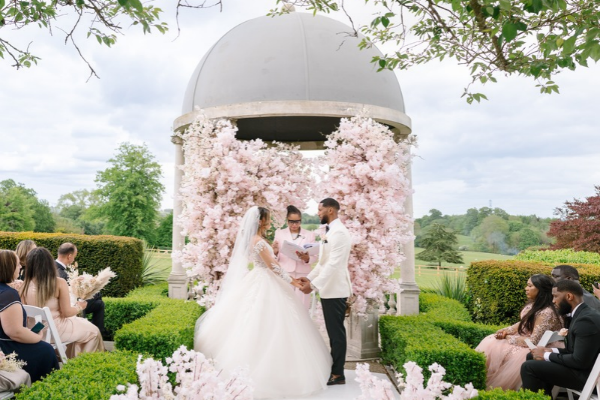 A couple exchange their vows underneath the Dome at Froyle Park - an exclusive-use Hampshire wedding venue.