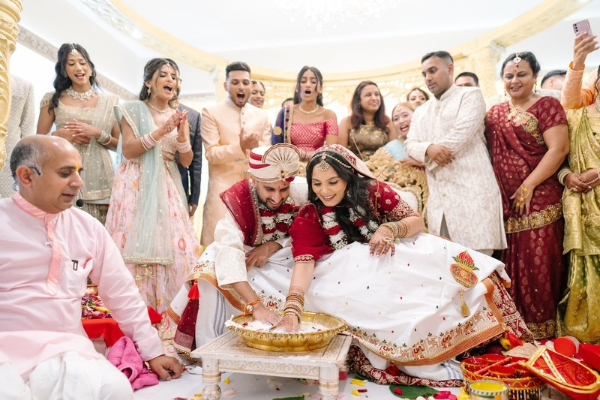 Hindu wedding game being played at Froyle Park during a multi-day wedding celebration.